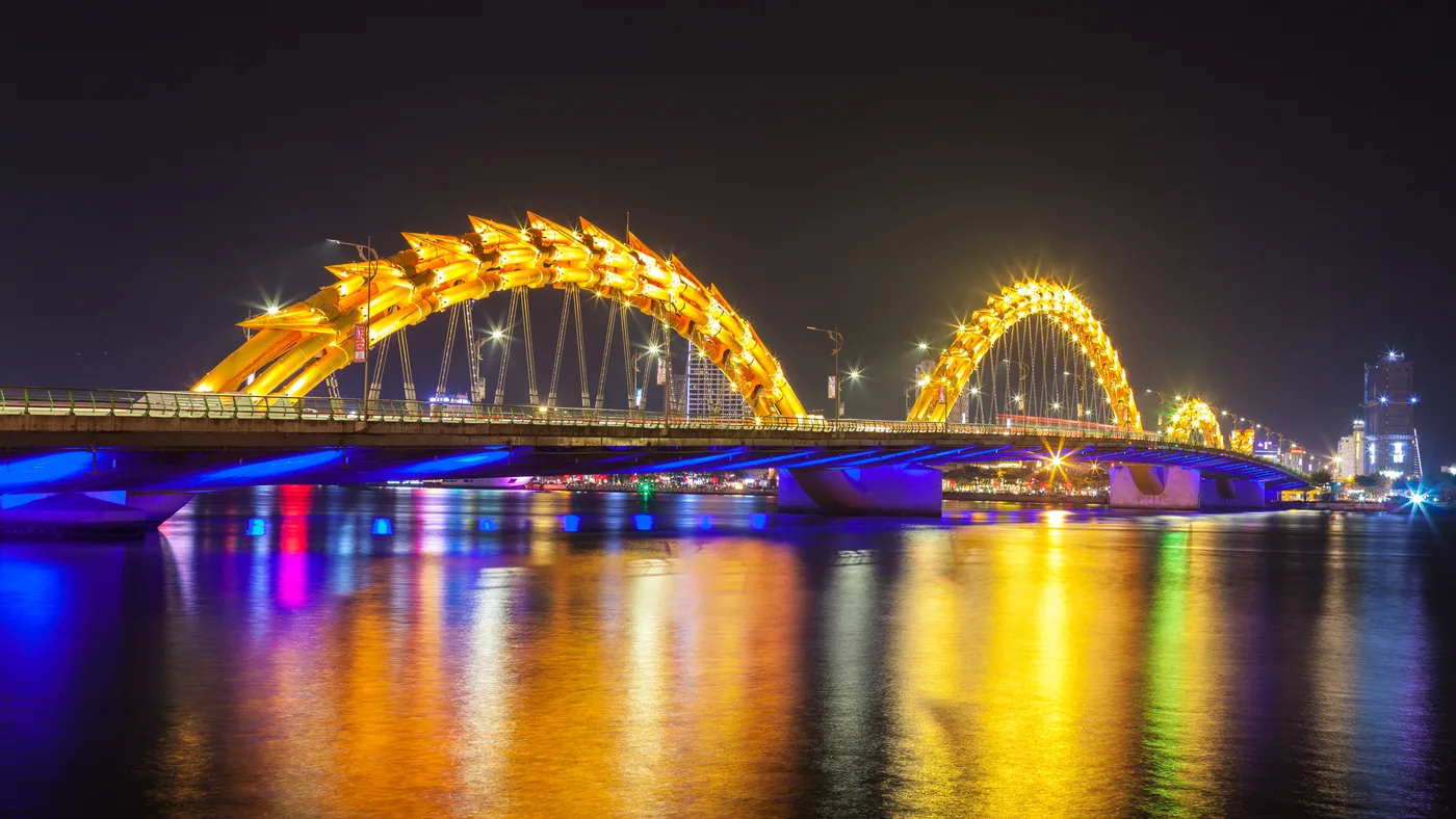 The Dragon Bridge lit up over the Han River at night, Da Nang