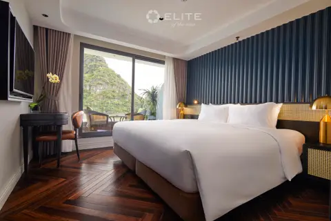 Senior cabin with a double bed, dressing table and sliding door to the private balcony